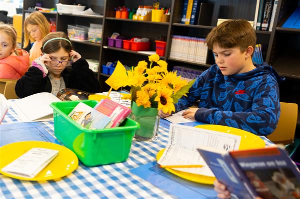 Students browsing new books that have been added to the Scales Library.